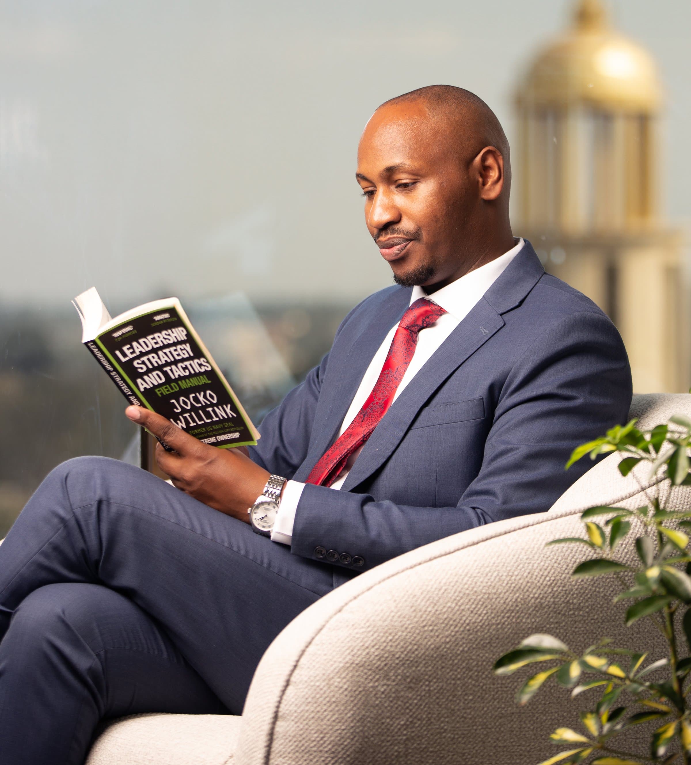 Coach Marangu reading, Nairobi behind him